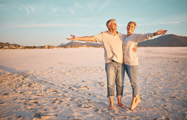 Love, beach and summer with a senior couple standing together on the sand on a sunny day. Travel,...