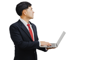 Asian handsome businessman in suit holding laptop and looking up
