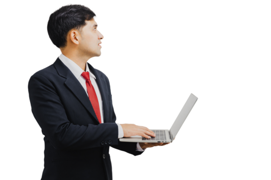 Asian handsome businessman in suit holding laptop and looking up