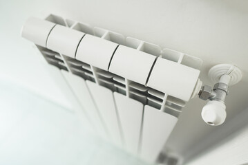 Metal radiator with adjustable valve inside the apartment.