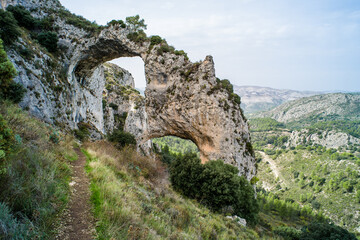Los Arcs hiking path. a tourist route surrounded by greenery, mountains, valleys, natural rock bridges. Ruta and los Arcos de Castillos