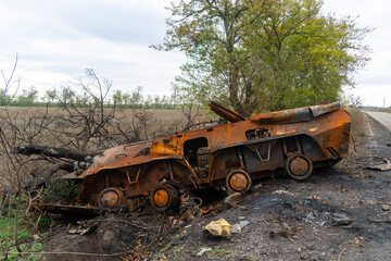 War in Ukraine. 2022 Russian invasion of Ukraine. Countryside. After the battle. Destroyed burnt combat vehicle stands on the side of the road