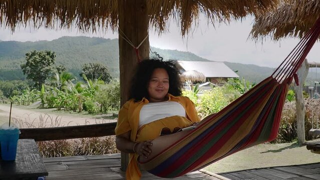 Beautiful black girl enjoying her time in a hammoc. (Thailand)