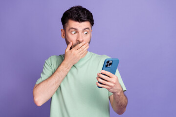 Photo portrait of attractive young man hold device cover mouth terrible news dressed stylish gray...