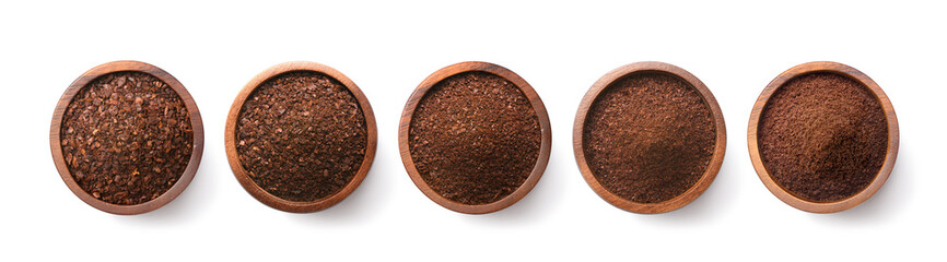 Flat lay of Different types of grinds coffee in wooden bowl isolated on white background. Clipping path.