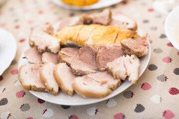 set of cold cuts of cooked chicken and pork meat on plate