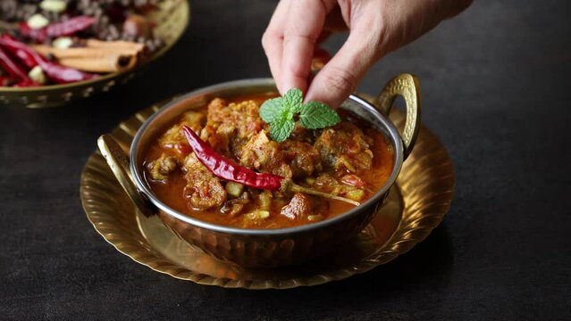 Traditional homemade Mutton curry from Asian cuisine. Chukhandar gosht. Spicy delicious meat beef curry. Bowl of tasty mutton roast Indian spices. side dish of Ghee rice, Appam, Parotta, Puttu