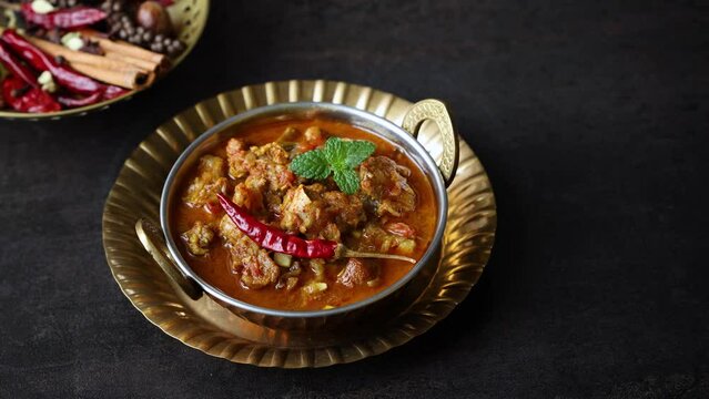 Traditional homemade Mutton curry from Asian cuisine. Chukhandar gosht. Spicy delicious meat beef curry. Bowl of tasty mutton roast Indian spices. side dish of Ghee rice, Appam, Parotta, Puttu