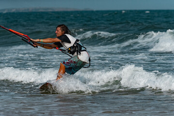 Kitesurfing on the waves of the sea in Mui Ne beach, Phan Thiet, Binh Thuan, Vietnam. Kitesurfing, Kiteboarding action photos Kitesurfer In action