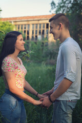 Fototapeta na wymiar Teenage couple in love holding hands in the spring nature