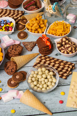 Salty and sweet snacks. Table of salty and sweet snacks. Large group of unhealthy food