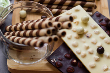 Sweet table with chocolate waffles, chocolate and ice cream on a black background