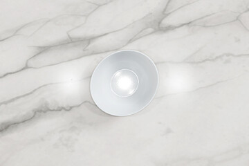 White cereal bowl on marble kitchen counter. Empty porcelain bowl. Digitally generated.