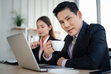 Asian businessman and secretary working together in the office. Teamwork concept.