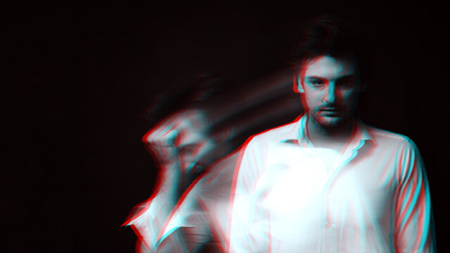Abstract blurry portrait of a psychopathic man with schizophrenic diseases and split personality. Black and white with 3D glitch virtual reality effect