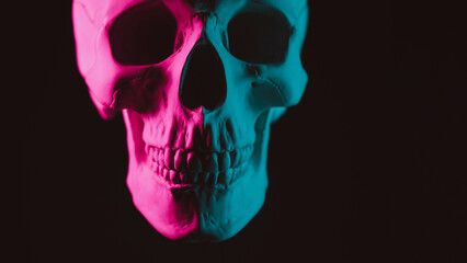 Obraz premium human skull with pink green neon light on dark background