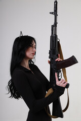 Slender glamour young woman with assault rifle