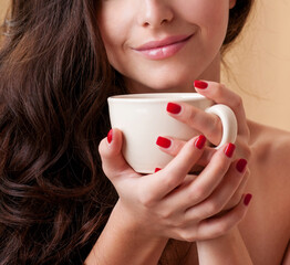 Beautiful woman holding a cup of coffee. Aroma of coffee - 541461360