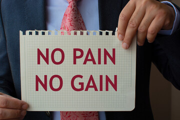The paper in the hand of the man in the suit reads ''no pain no gain''.