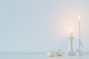 Fototapeta na wymiar white burning candles on background white wall