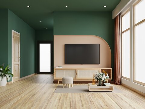 Living room with tv on cabinet in dark green color wall,minimalist muji style.