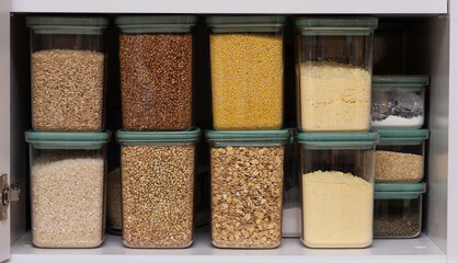 Cereals in containers, buckwheat, oatmeal, millet, rice, green buckwheat.