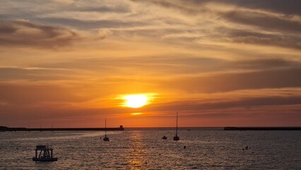 Naklejka na ściany i meble beautiful sunset on the coast over the sea. sunset from the beach.