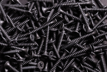 Metal, Stainless Steel Self Tapping Screws on black wooden background