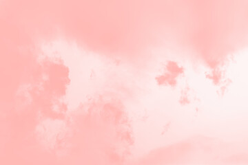 Pink coral color clouds on a pale pink sky background