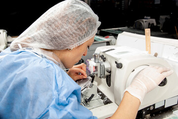 Scientist working on a rotary microtome to obtain sections from a paraffin-embedded specimen.