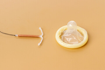 T-shaped intrauterine birth control device with condoms. Contraception concept