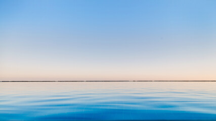 The blue transparent water in the pool merges with the sky to copy the space.