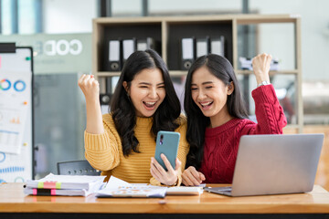 Independent Asian woman Have an idea and work in the office Confident in smart casual wear. Ready to take pictures with a happy lollipop mobile phone.