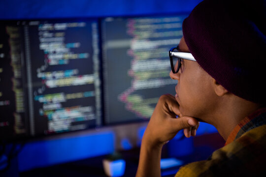Profile cropper portrait of concentrated hardware expert hand touch chin operating database night office indoors