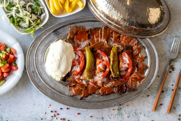 Turkish iskender kebab on gray background. Traditional flavors. Doner kebab made from beef and...