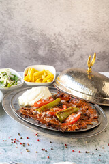 Turkish iskender kebab on gray background. Traditional flavors. Doner kebab made from beef and lamb. close up
