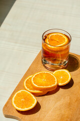 Obraz na płótnie Canvas Oranges sliced on a wooden surface in the light of the sun.
