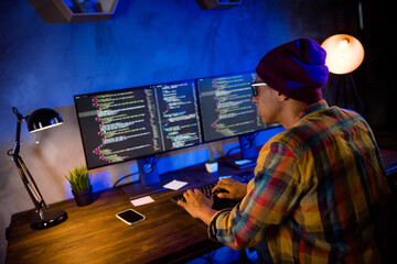 Profile photo of clever hacker guy sitting chair keyboard typing database optimization evening...
