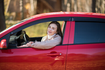 brunette girl travels in autumn in a red car, the concept of travel and autumn holidays, vacation