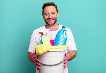 middle age man housekeeper concept with clean products sport coach concept with a soccer ball