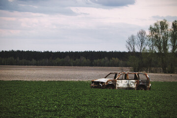 Burnt car in a field near Kyiv