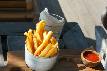 French fries on the table. Sauce and tissue next to it. Good illustration for meal on vacation.