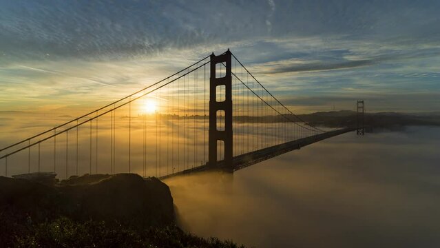 Aerial Time Lapse Lockdown Shot Of Person Photographing Golden Gate Bridge Over Clouds Moving On Strait In City At Sunset - San Francisco, California