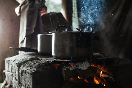 close up of two iron pots on top of a traditional colombian stove. stove lit with wood as fuel. traditional cooking on a farm in colombia. concept of typical gastronomy.