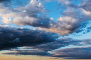 Naklejka na ściany i meble Dark cloudy sky at sunset, natural background texture