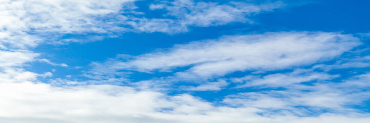 Blue sky with white clouds on a daytime. Natural panoramic photo
