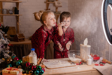 two small children cook a pie for Christmas and shoot a cooking blog. children bloggers