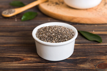 Chia seeds in bowl and spoon on colored background. Healthy Salvia hispanica in small bowl. Healthy superfood