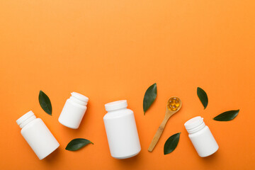 supplement pills with medicine bottle health care and medical top view. Vitamin tablets. Top view mockup bottle for pills and vitamins with green leaves, natural organic bio supplement, copy space