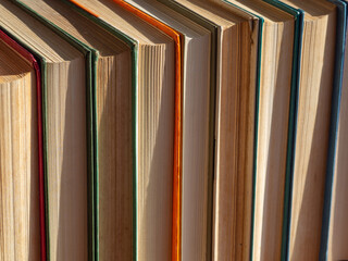 Background of a stack of books. Stack of hardcover books background texture with copy space